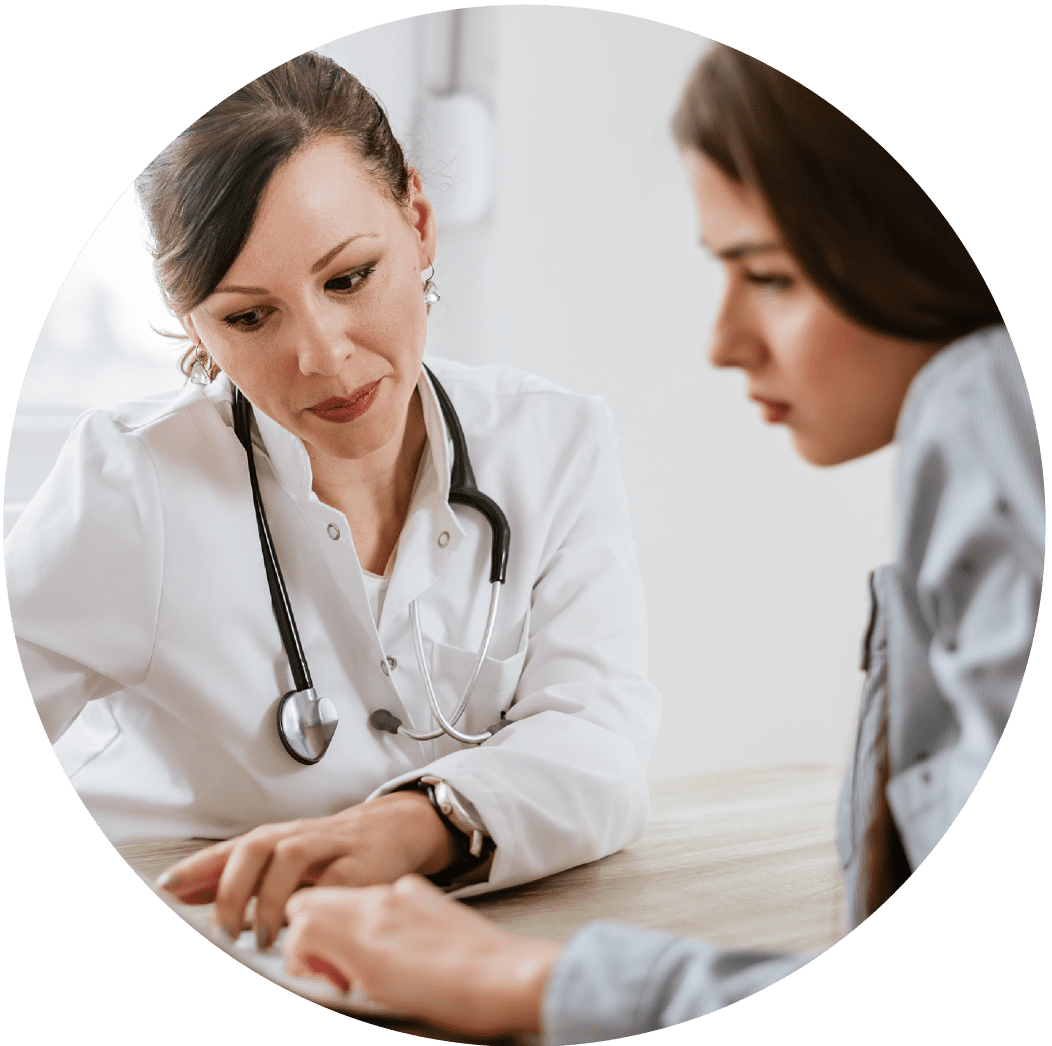 Woman doctor with woman patient discussing explant so the woman can heal from breast implant illness.